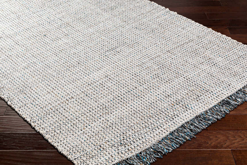 Close-up of the Beige Teal Aron Area Rug showing its woven texture and teal, brown, and charcoal flecks. Corner