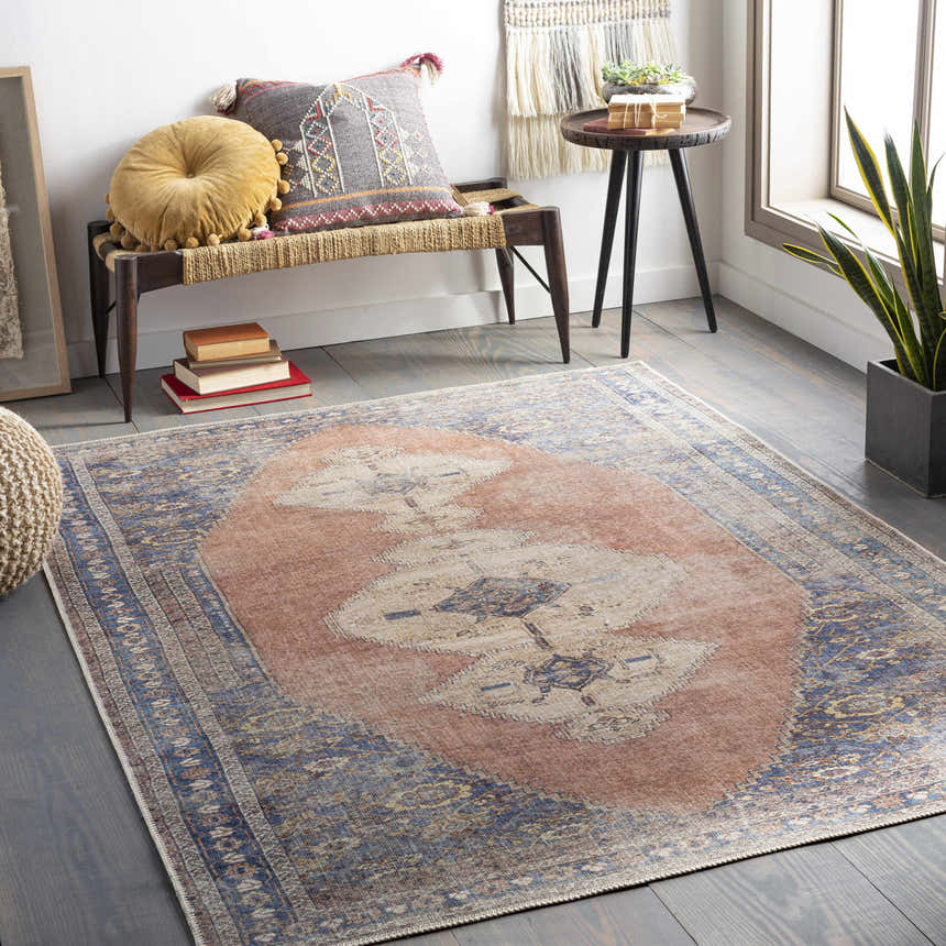 Living room scene with a Stakeford Washable Area Rug. Light blue, tan, and peach colors in a bohemian-style room. Roomscene-Rectangle