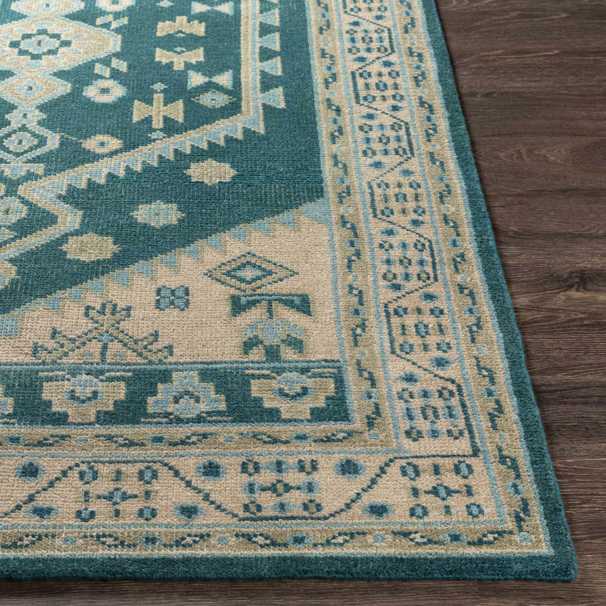 Close up of the hand-knotted Stepps Area Rug featuring aqua, beige, and sage tones with a traditional oriental pattern. Front