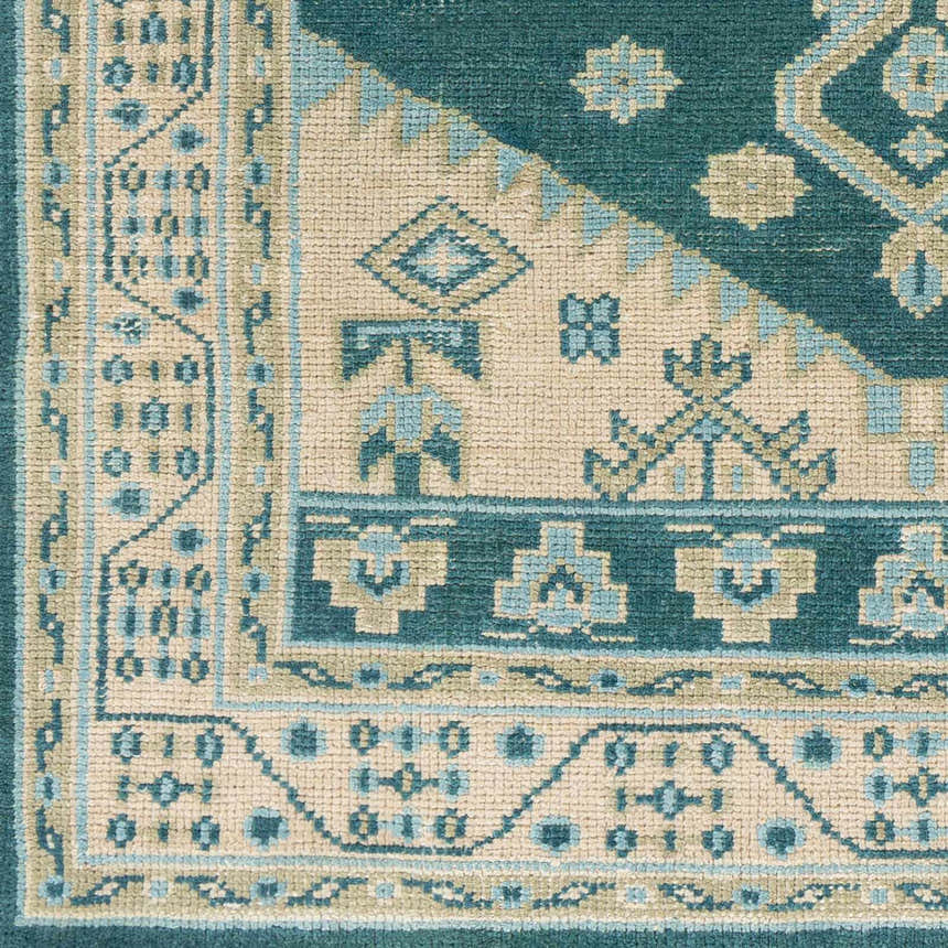 Close-up of the hand-knotted Stepps Area Rug. Aqua, beige, sage, and teal oriental rug with traditional geometric patterns. Swatch