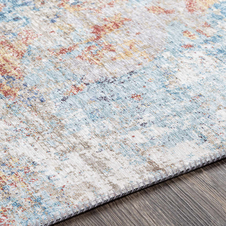 Close-up of the Stallingborough Area Rug, showcasing its contemporary design with blue, rust, and cream colors. Texture