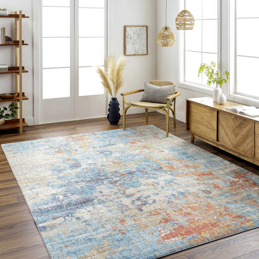 Living room scene with blue, cream, and rust Stallingborough Area Rug, wood floors, woven chair, and modern wood cabinet. Roomscene-Rectangle