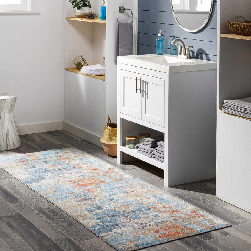 Bathroom scene with blue and brick red Stallingborough Area Rug runner on gray wood floor. Roomscene-Runner