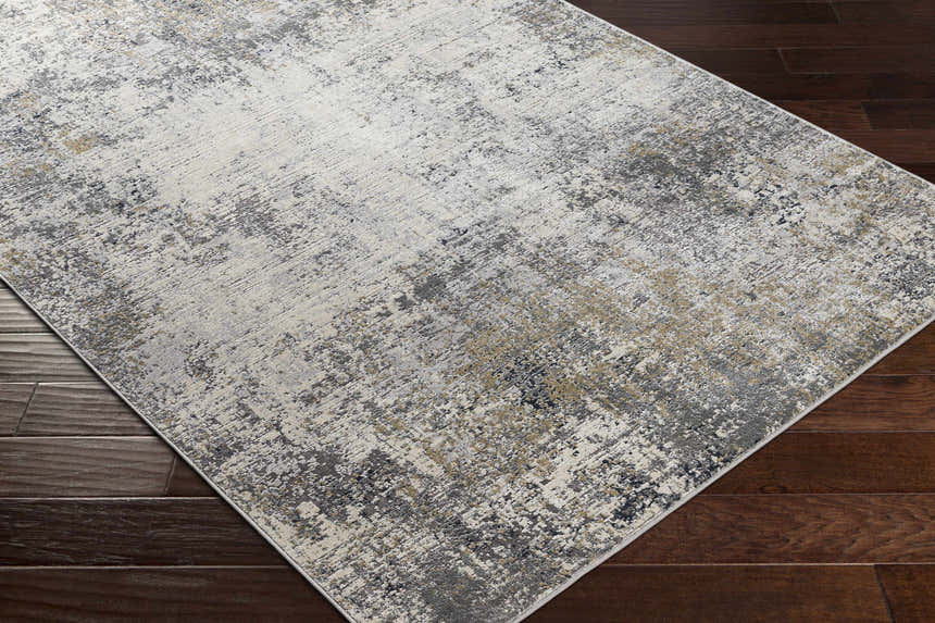 Close-up of the Standlake Textured Luxe Area Rug featuring a charcoal, cream, and gray abstract design. Corner