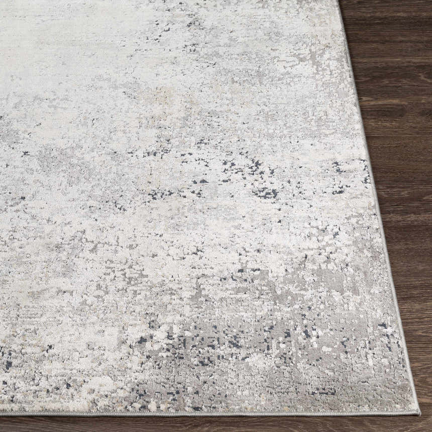 Close-up of the Standlake Textured Luxe Area Rug. Charcoal, cream, and gray abstract pattern. Machine woven. Front