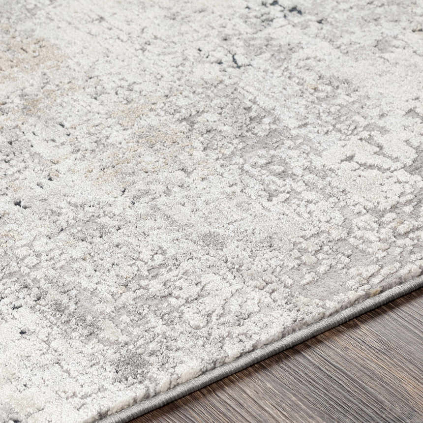 Close up of the Standlake Textured Luxe Area Rug showing its cream, gray, and charcoal abstract design. Texture