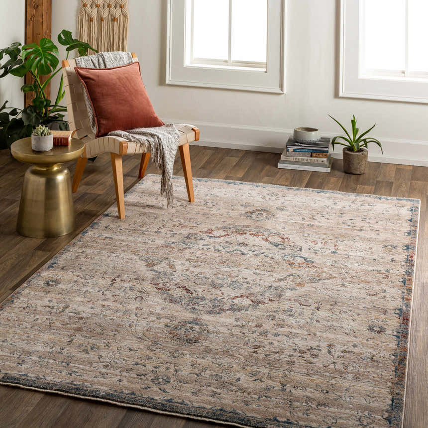 Entryway with Stratmoor Area Rug in beige, blue, and burnt orange. Traditional style with chair, side table, and plants. Roomscene-Rectangle