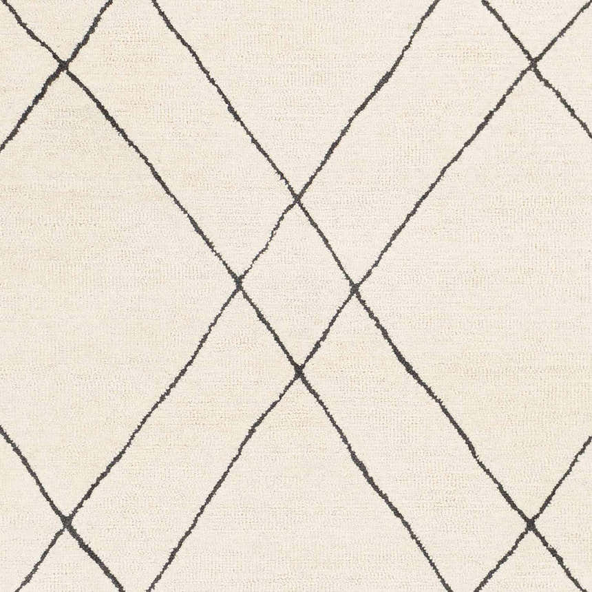 Close-up of the Strathalbyn Area Rug. Cream wool rug with a simple black diamond pattern. Hand-tufted texture. Swatch
