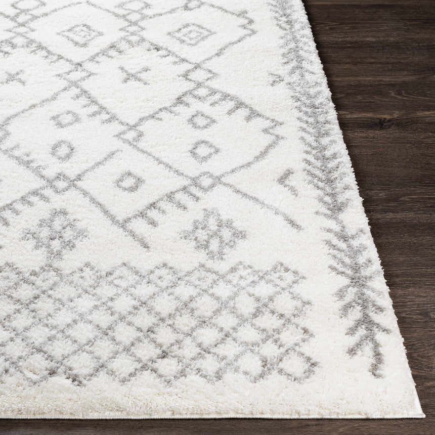 Close up of the Sutterton Area Rug. Cream rug with gray geometric pattern and soft, plush texture. Front