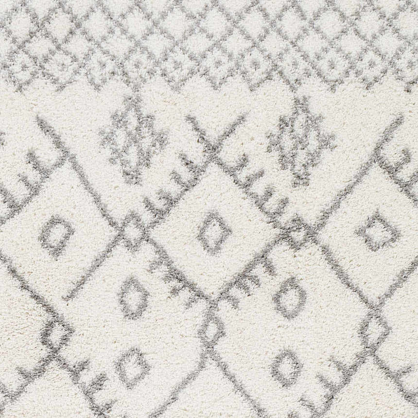 Close-up of the Sutterton Area Rug. Cream rug with a geometric gray diamond pattern and soft texture. Swatch
