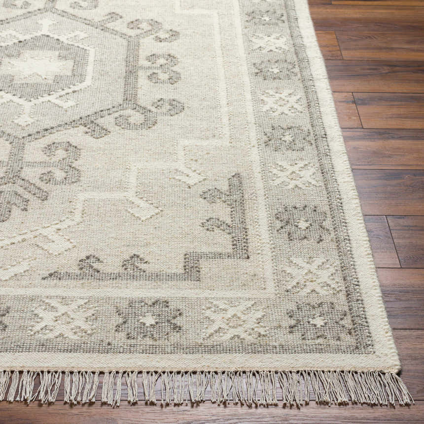 Close up of hand woven Afra Area Rug showing gray traditional pattern and wool texture. Front