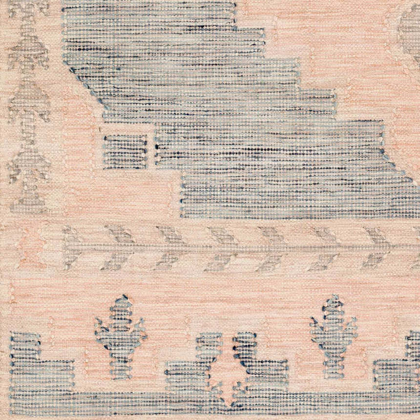Close-up of the hand-woven Lana Area Rug. Features a farmhouse design in light pink and blue wool. Clearance item. Swatch