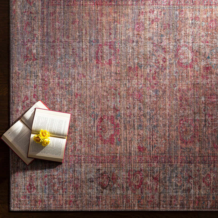 Tajao Washable Printed Jute Rug in warm tones with oriental pattern. Open book with yellow flowers on the rug. Styleshot