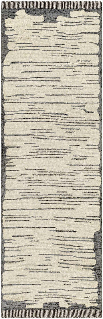 Close-up of the Tapas Wool Area Rug. Hand-tufted rug with cream and charcoal horizontal stripes and a black fringed border. Design-Runner-268