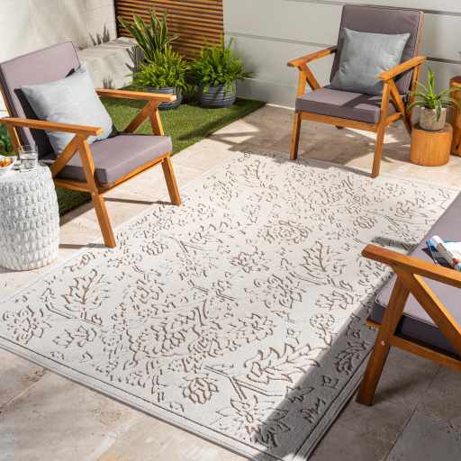 Outdoor patio scene with gray chairs and the Tabuan 3D Outdoor Area Rug in gray, light peach, and nutmeg. Roomscene-Rectangle