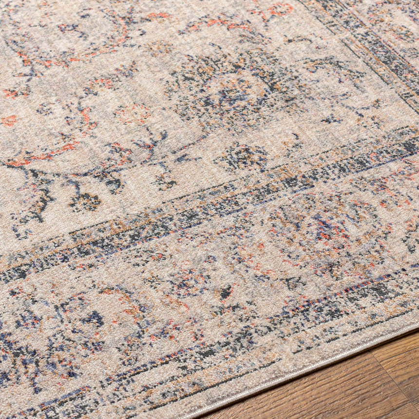 Close-up of the Temelec Area Rug, a beige polyester rug with burnt orange, charcoal, and slate floral and oriental patterns. Texture