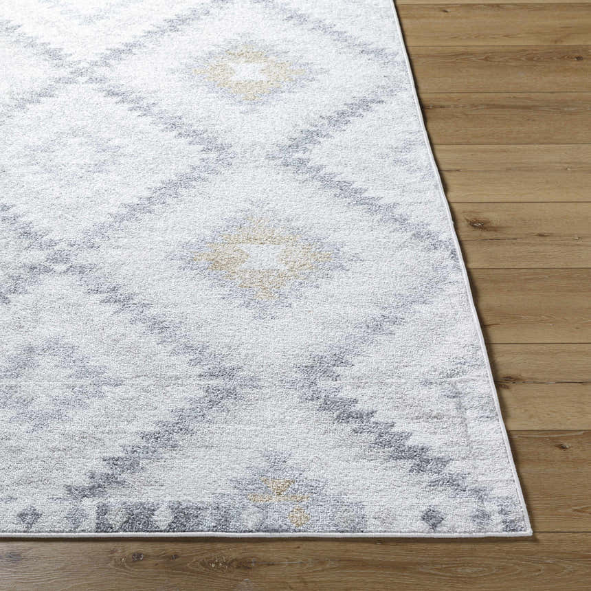 Close up of the Tyipa Area Rug featuring a Southwestern diamond pattern in charcoal, cream, gray, and mustard. Front