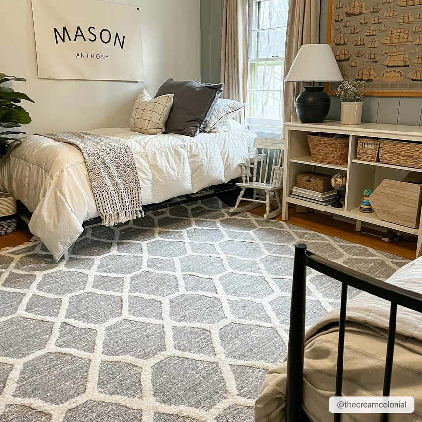 Bedroom scene with gray and bone Mpumalanga Area Rug, white bedding, and bookshelf. Neutral, modern style. Roomscene-Rectangle