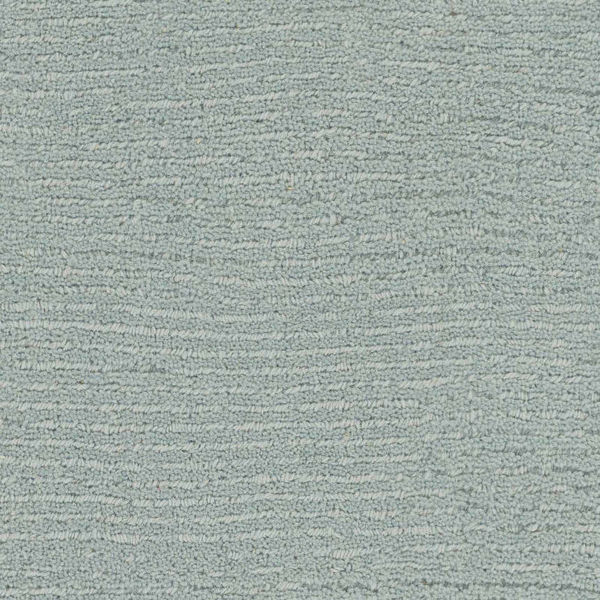 Close-up of the hand-loomed Brockton Solid Dusty Sage Wool Rug, showing its soft texture and subtle striped pattern. Swatch