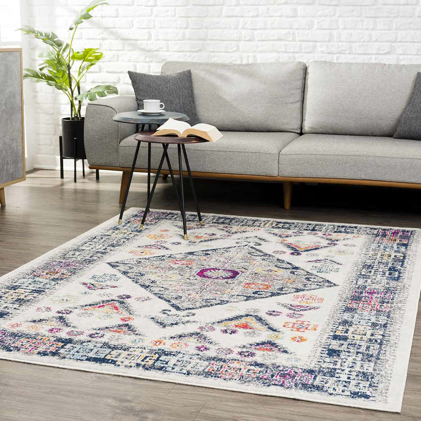 Living room scene with gray sofa and Tigriv Ivory 2312 rug. Bohemian style rug in ivory, navy, gray, and orange. Roomscene-Rectangle