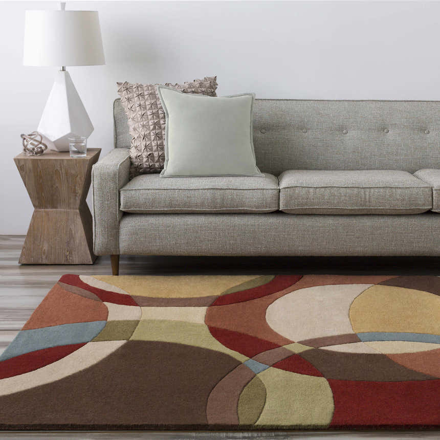 Living room scene with a gray sofa and the Tilbury Modern Hand Tufted Wool Rug featuring a geometric pattern in brown, red, and tan. Roomscene-Rectangle