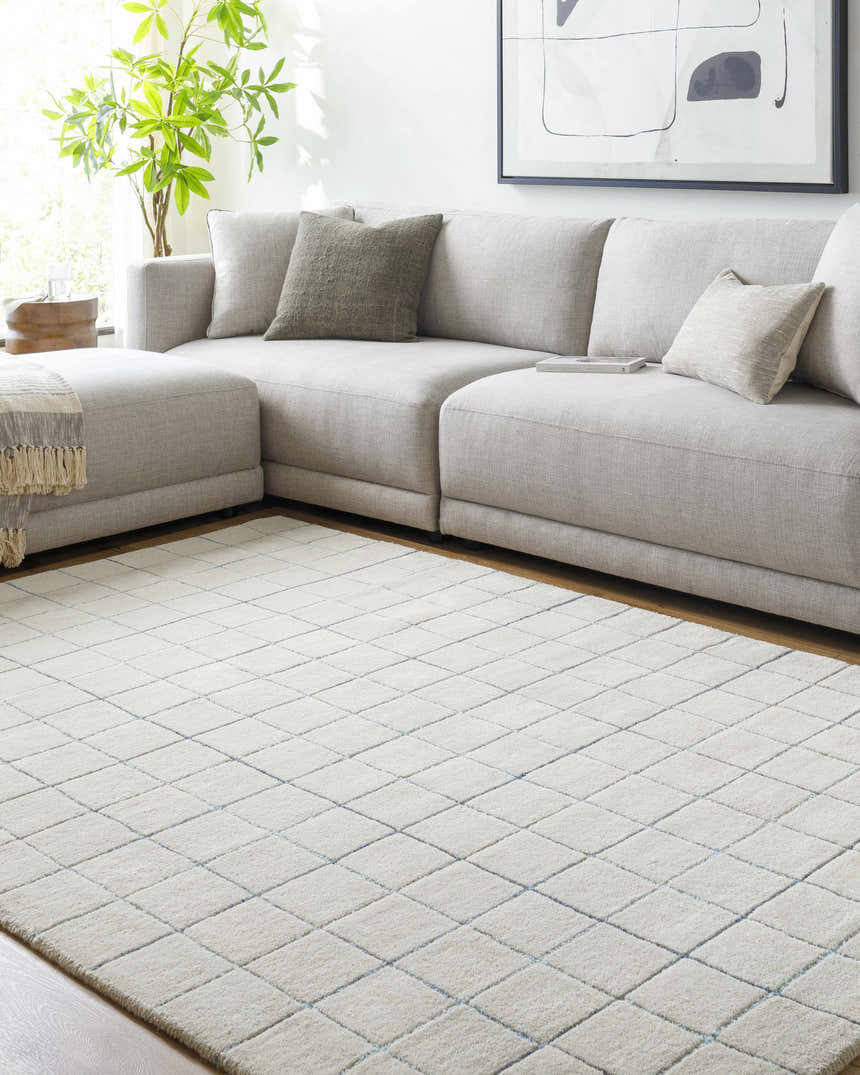 Living room with a gray sectional sofa and Toshi Beige Grid Wool Rug. Roomscene-Rectangle