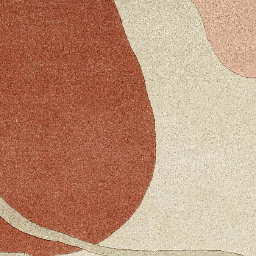 Close-up of the Tomingad Area Rug. Hand-tufted wool rug with brick red, oatmeal, and dusty pink geometric shapes. Swatch