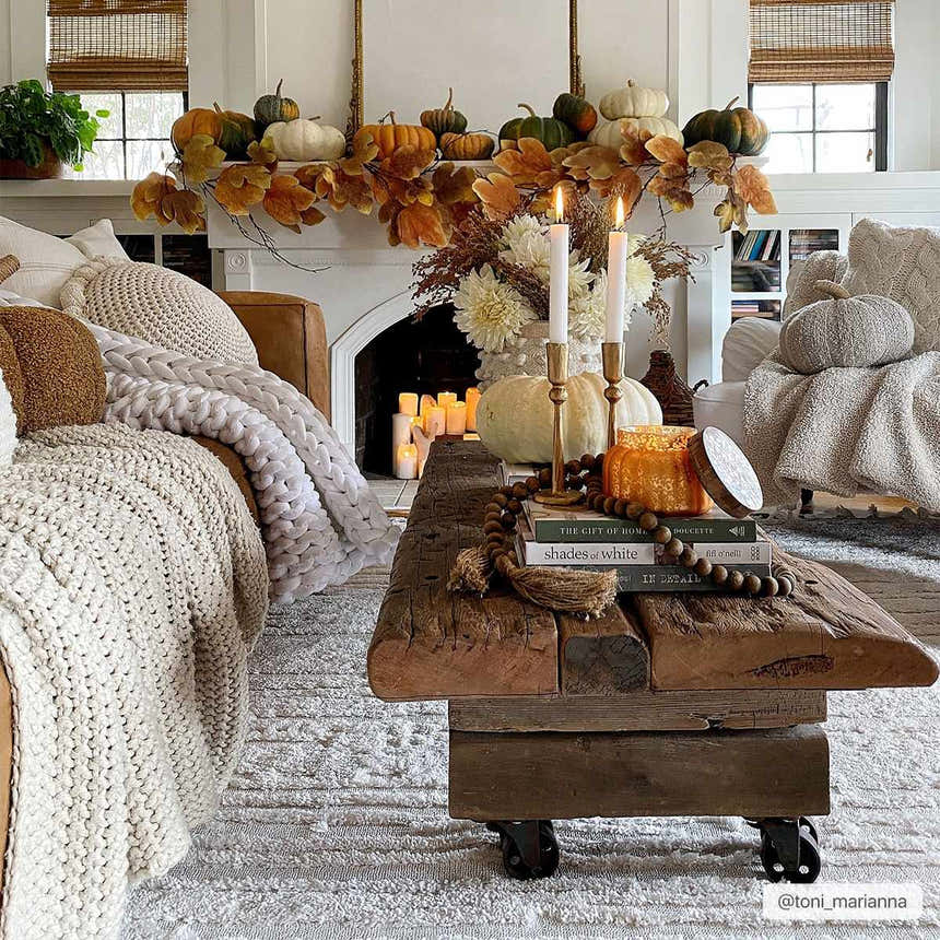 Fall living room scene with Ibarra Textured Ivory Rug, rustic wood coffee table, fireplace, and pumpkins. Roomscene-Rectangle