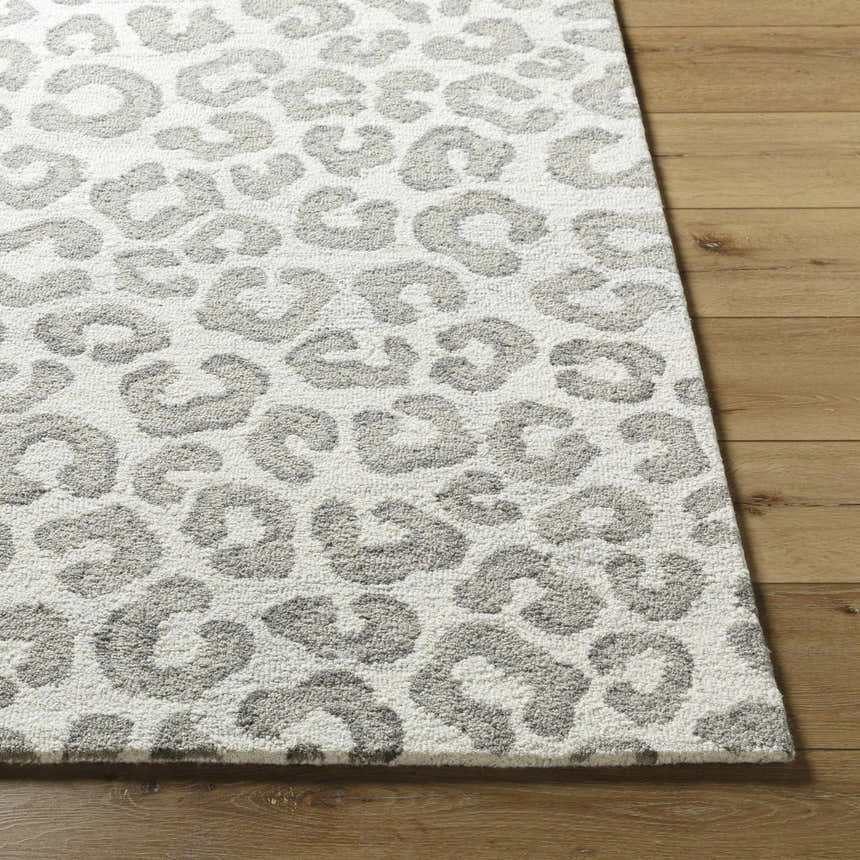 Close-up of the Tomas Area Rug showing its light silver and silver gray leopard print design and wool texture. Front
