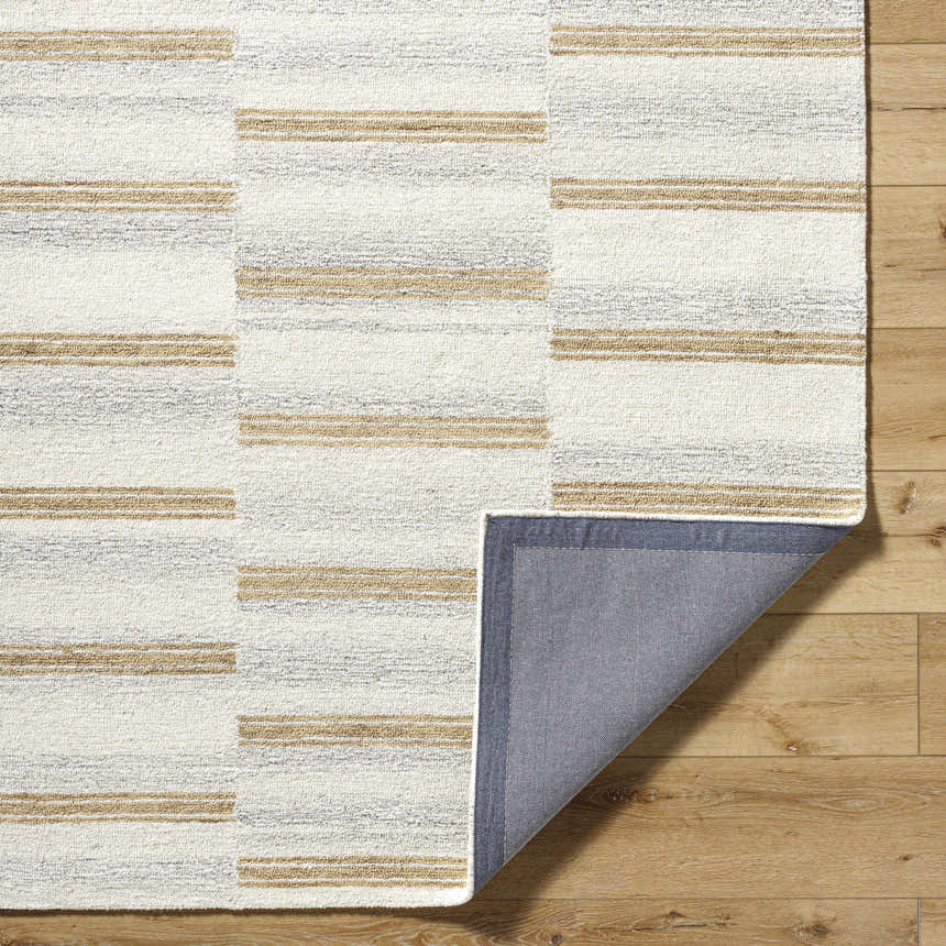 Close-up of the Toren Broken-Striped Area Rug showing ash, pearl, and prairie dust stripes. Hand-tufted wool texture visible. Fold
