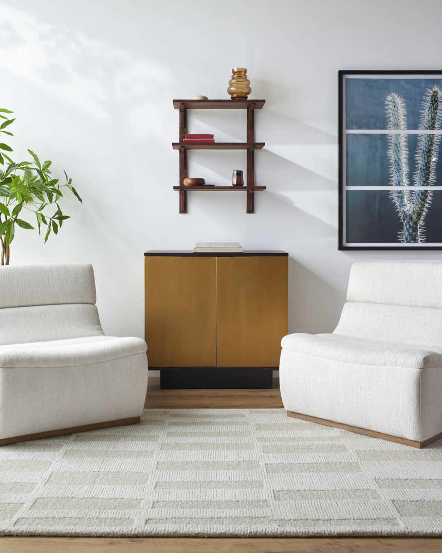 Living room scene with two white chairs on a Teige Light Silver Area Rug with a geometric pattern. Roomscene-Rectangle