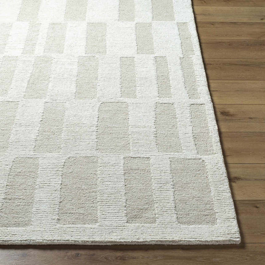 Close-up of the hand-tufted Teige Light Silver Area Rug. Features a contemporary geometric pattern and wool texture. Front