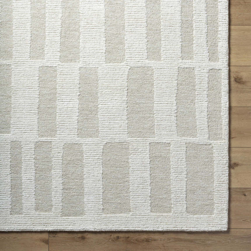 Close-up of the hand-tufted Teige Light Silver Area Rug. Features a contemporary striped pattern in light silver and sterling gray. Corner
