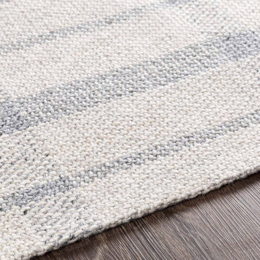 Close-up of the hand woven Verdon Light Gray Plaid Rug showing texture and gray, oatmeal, and light gray colors. Texture