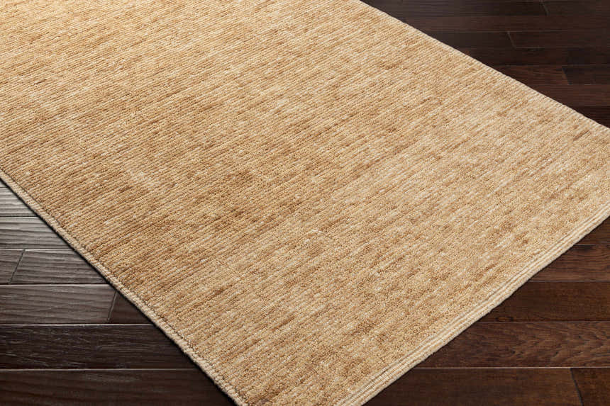 Close up of the hand-loomed Vezirhan Area Rug in peach and dark red, showcasing texture and construction. Corner