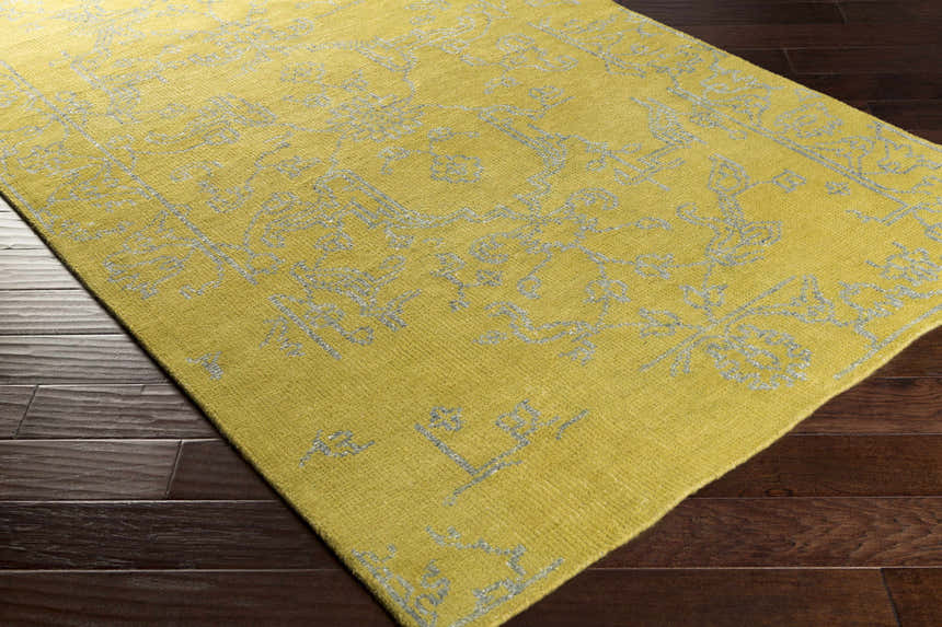 Close-up of the Voorhees Area Carpet in olive and slate, showcasing its hand-knotted texture and traditional design. Corner