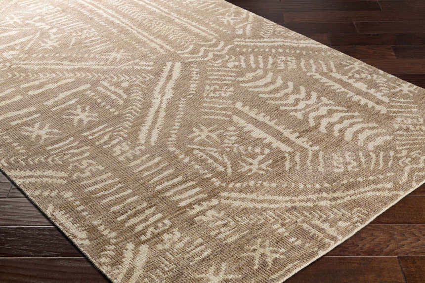 Close-up of the Wainfleet Jute Carpet showing its hand-knotted construction and farmhouse-style geometric pattern in beige and cream. Corner