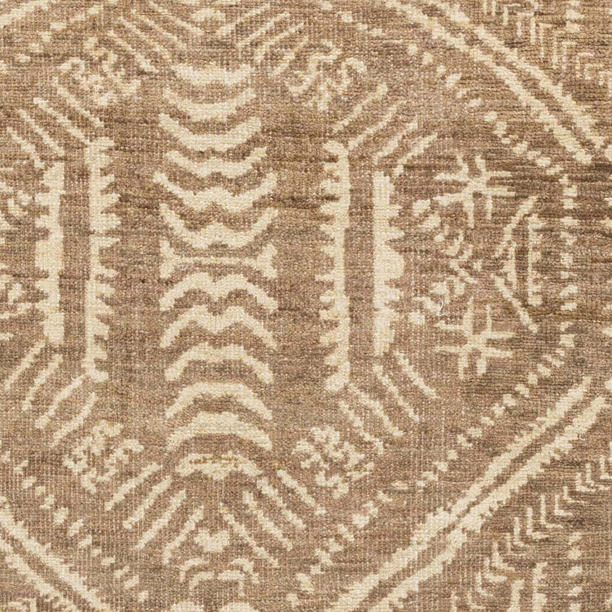 Close-up of the Wainfleet Jute Carpet showing its hand-knotted texture and farmhouse-style geometric pattern in brown and beige. Swatch