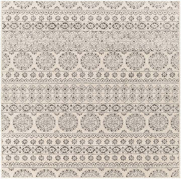 Close up of the Warroad Area Rug. Beige rug with charcoal, gray, and light beige bohemian-style pattern. Design-Square-7
