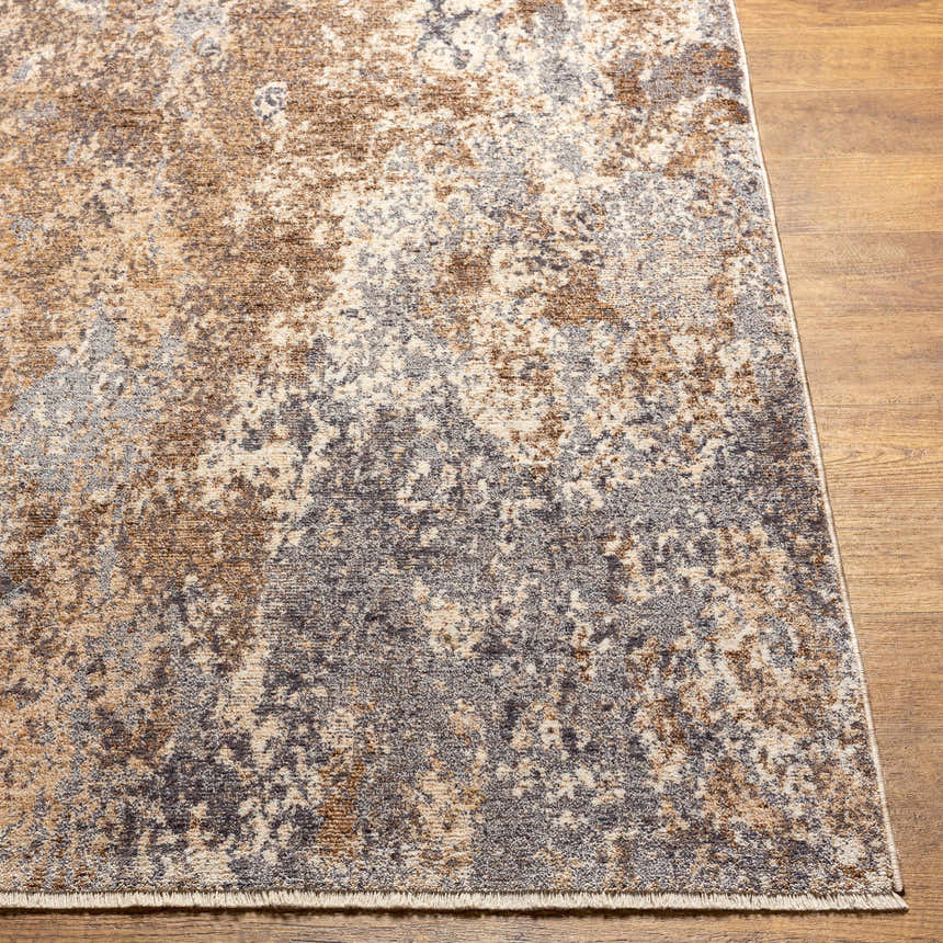 Close up of the Woodmoor Area Rug showing bone, dark gray, and walnut colors on a wood floor. Front