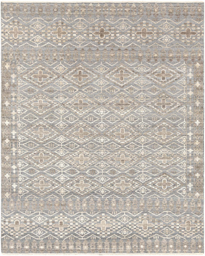 Close-up of the hand-knotted Woodsfield Premium Rug. Beige, brown, and gray geometric pattern. Wool rug texture. Design-Rectangle
