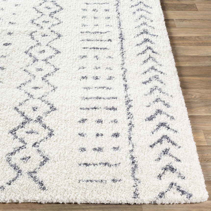 Close up of the Wedowee Area Rug. White shag rug with gray geometric, tribal-inspired pattern. Bohemian style. Front