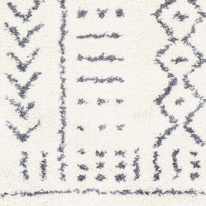 Close-up of Wedowee Area Rug. Shag rug with gray bohemian-inspired geometric pattern on white background. Soft texture. Swatch