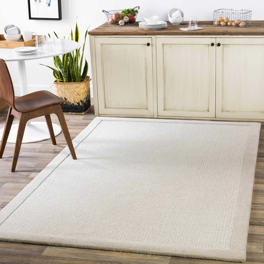 Light gray Winooski Area Rug in a dining room with a white table and wood chair. Roomscene-Rectangle