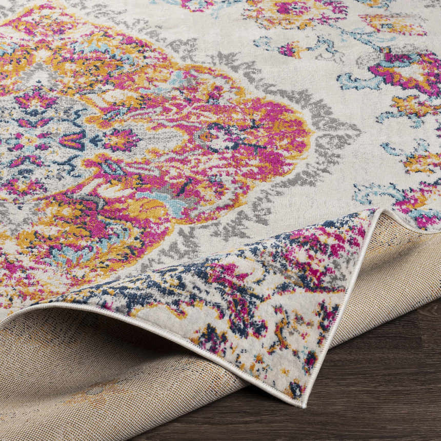 Wallsburg Magenta & Cream Area Rug close-up. Cream rug with magenta, saffron, and blue floral pattern. Polypropylene rug texture. Fold