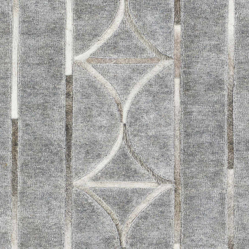Close-up of the Willingham Area Rug. Charcoal gray rug with light beige and gray geometric pattern and vertical stripes. Swatch