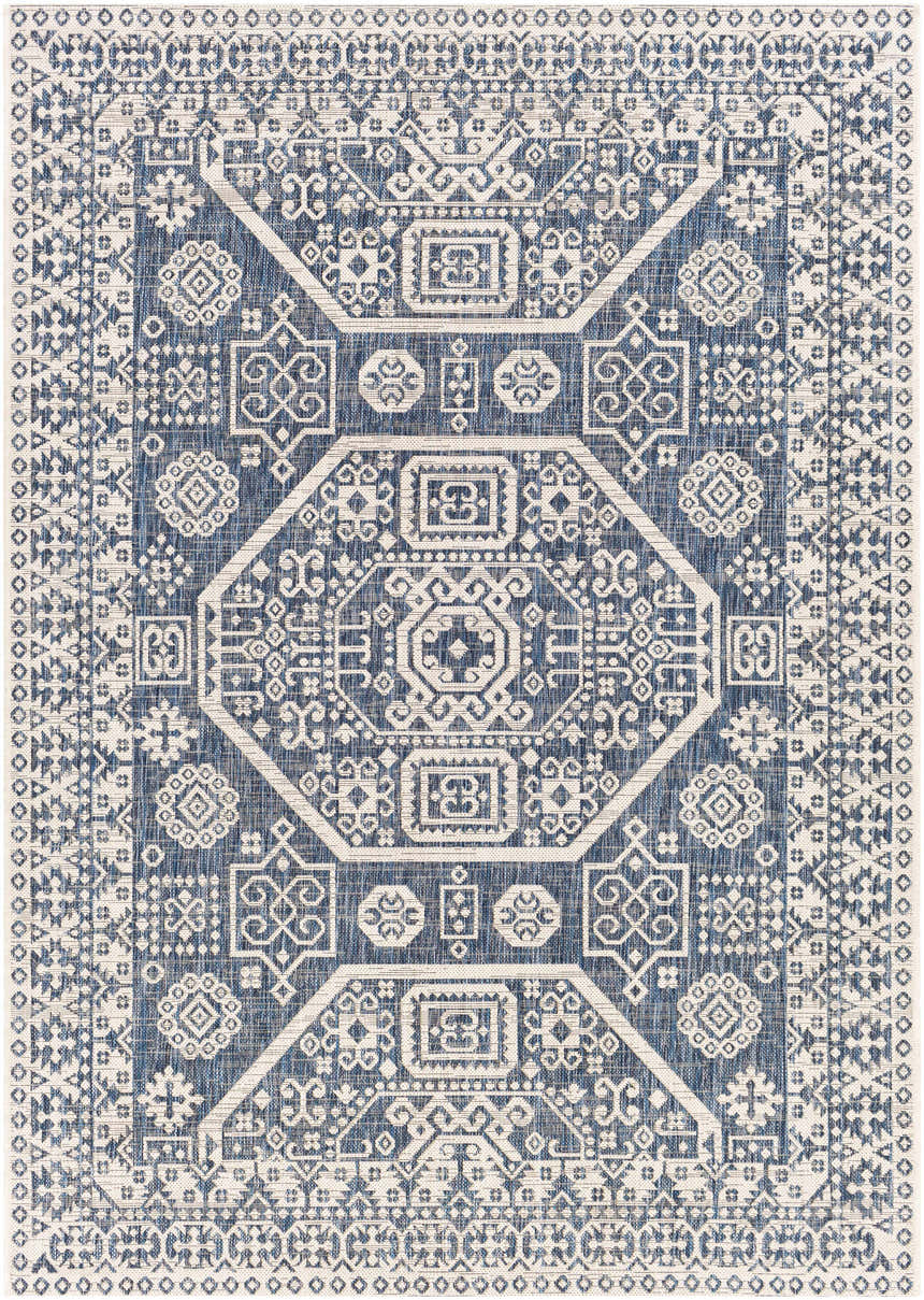 Detailed close-up of the Windaroo Area Rug. Features a blue and off-white bohemian-inspired geometric pattern. Design-Rectangle-5377