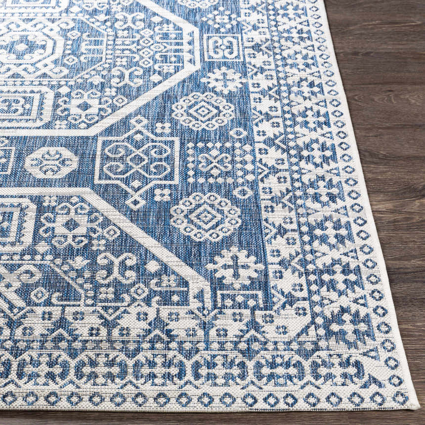Close-up of the Windaroo Area Rug. Bohemian style rug in dark blue and off-white with an oriental-inspired geometric pattern. Front