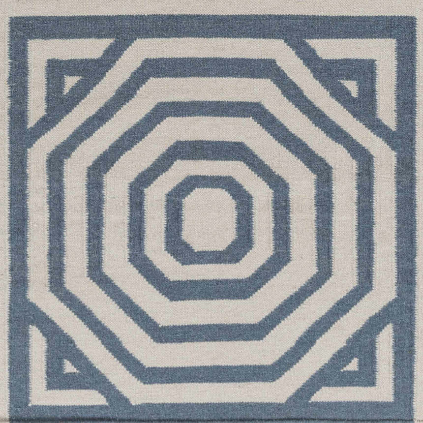 Close-up of Westbrook Area Rug: hand-woven wool with geometric pattern in dark blue and light gray. Swatch