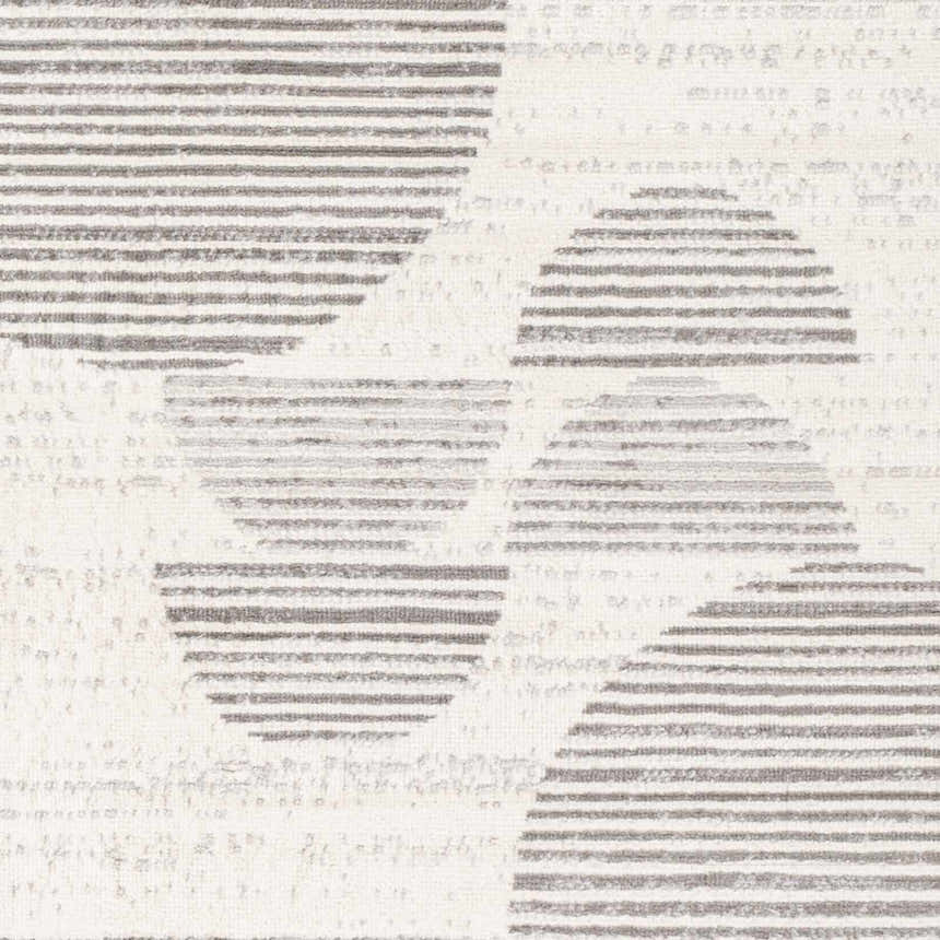 Close-up of Westcourt Area Rug. Geometric pattern in dark gray, nickel, pewter, and silverton on a textured, machine-woven rug. Swatch